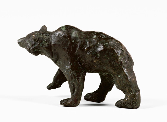 A bronze sculpture of a walking bear.