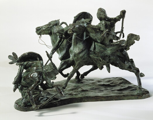 A bronze sculpture of two horses in mid-gallop, with both riders lunging toward a crouching man behind a shield.