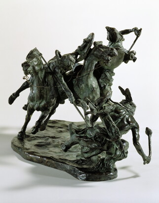 A bronze sculpture of two horses in mid-gallop, with both riders lunging toward a crouching man behind a shield.