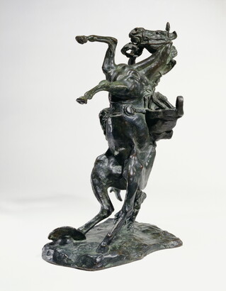 A bronze sculpture of a cowboy falling off the back of a rearing horse.