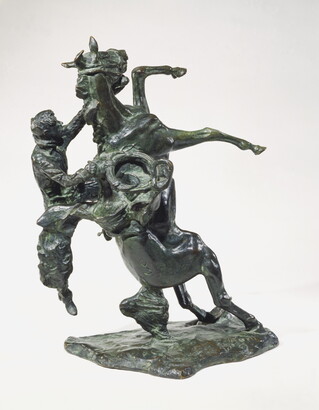 A bronze sculpture of a cowboy falling off the back of a rearing horse.