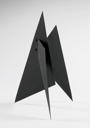 A black abstract tabletop sculpture with sharp points.