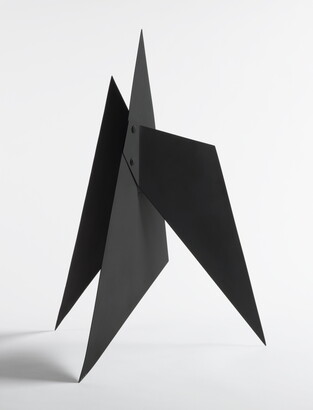 A black abstract tabletop sculpture with sharp points.