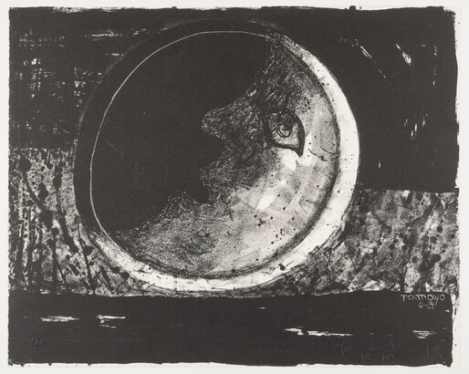 A black-and-white print of a crescent moon with an eye, nose, and mouth on a black and gray background.