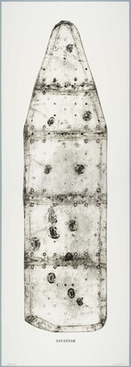 A black-and-white print of an ironing board filled with holes and dents, showing the shadows of its supporting structure, and with the word &quot;SAVANNAH&quot; below the image.