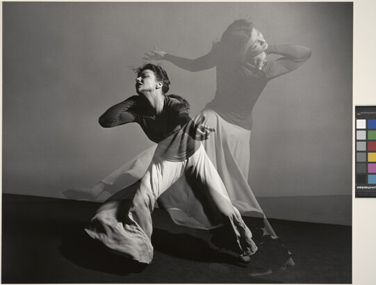 A double-exposed, black-and-white photograph of a female figure dancing dramatically.