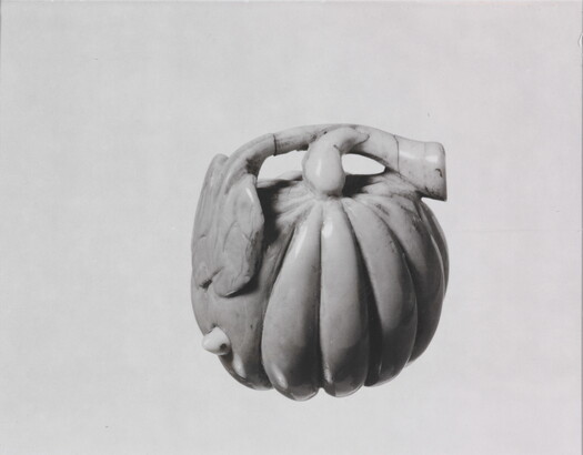 A black-and-white photograph of a ceramic pumpkin.