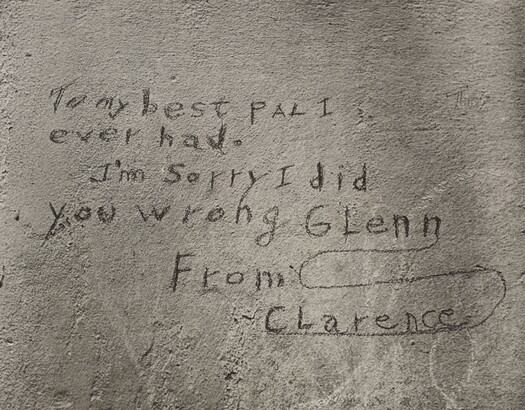 A black-and-white photograph of a note written on what looks like a cement wall that reads: &quot;To my best pal I ever had. I&#039;m sorry I did you wrong Glenn. From Clarence.&quot;