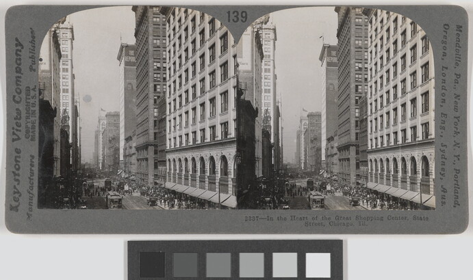 Two almost identical black-and-white photographs side by side of tall, city buildings next to a busy street with pedestrians and streetcars.