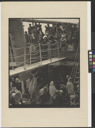 A black-and-white photograph of people outside on two decks of a crowded ship.