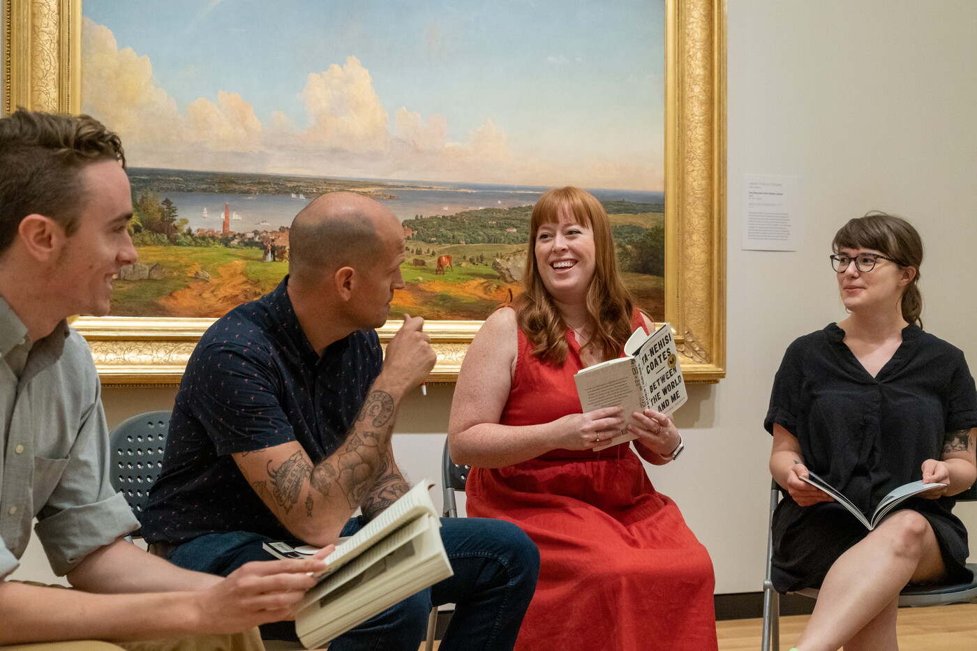 A group of people reading a book in one of the Carter&#039;s galleries.