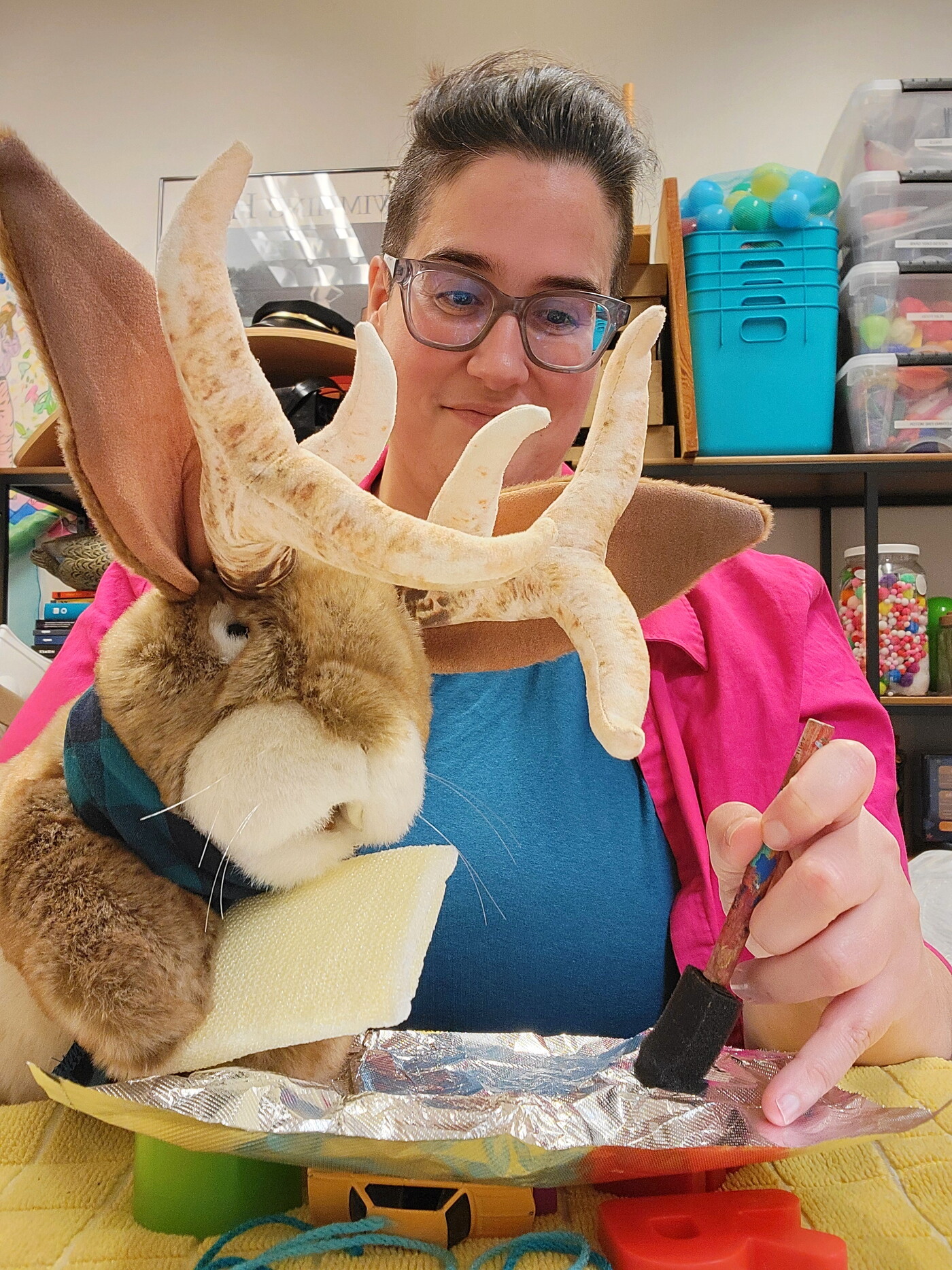 Prickles and his educator friend gently dab the foil with sponges around their letters.