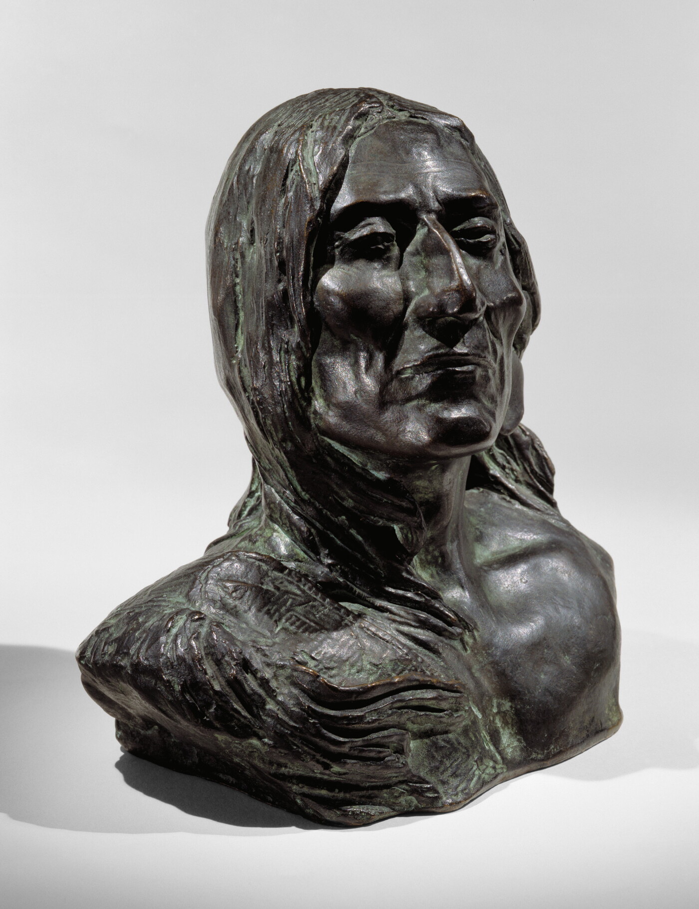 A bronze bust of an Indigenous person.