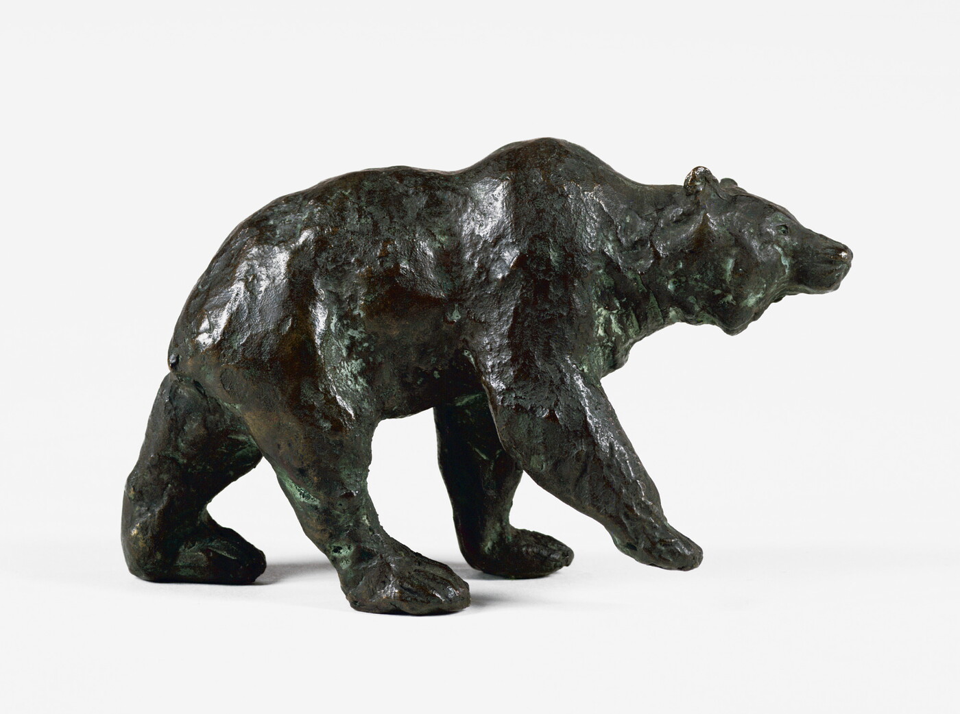 A bronze sculpture of a walking bear.