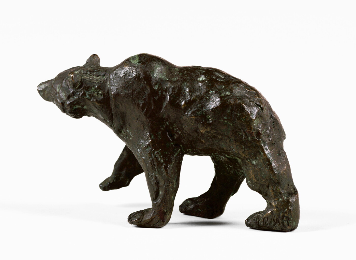 A bronze sculpture of a walking bear.