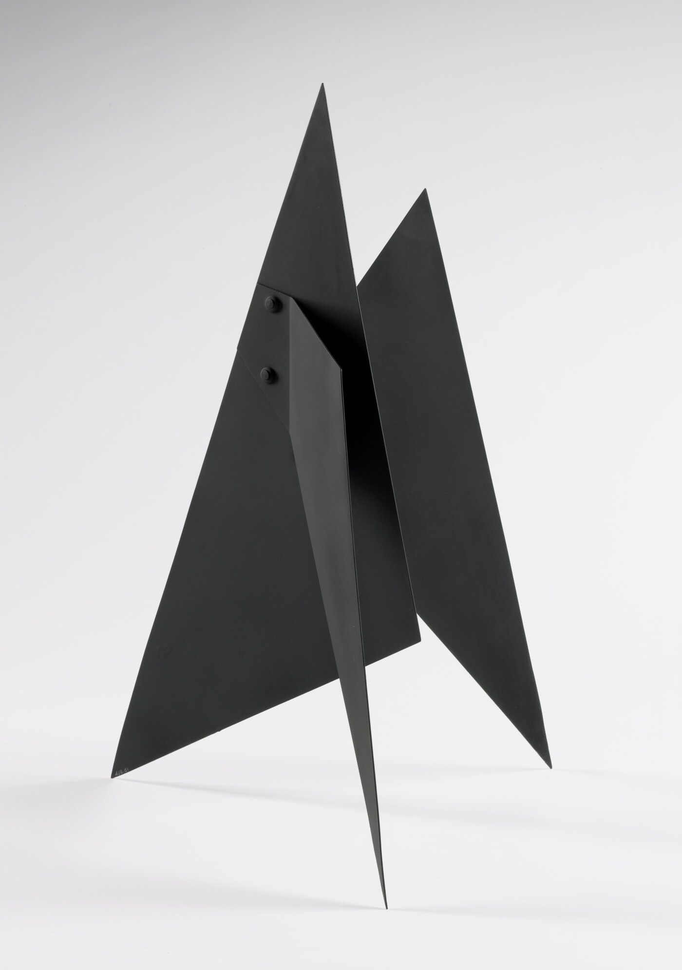 A black abstract tabletop sculpture with sharp points.