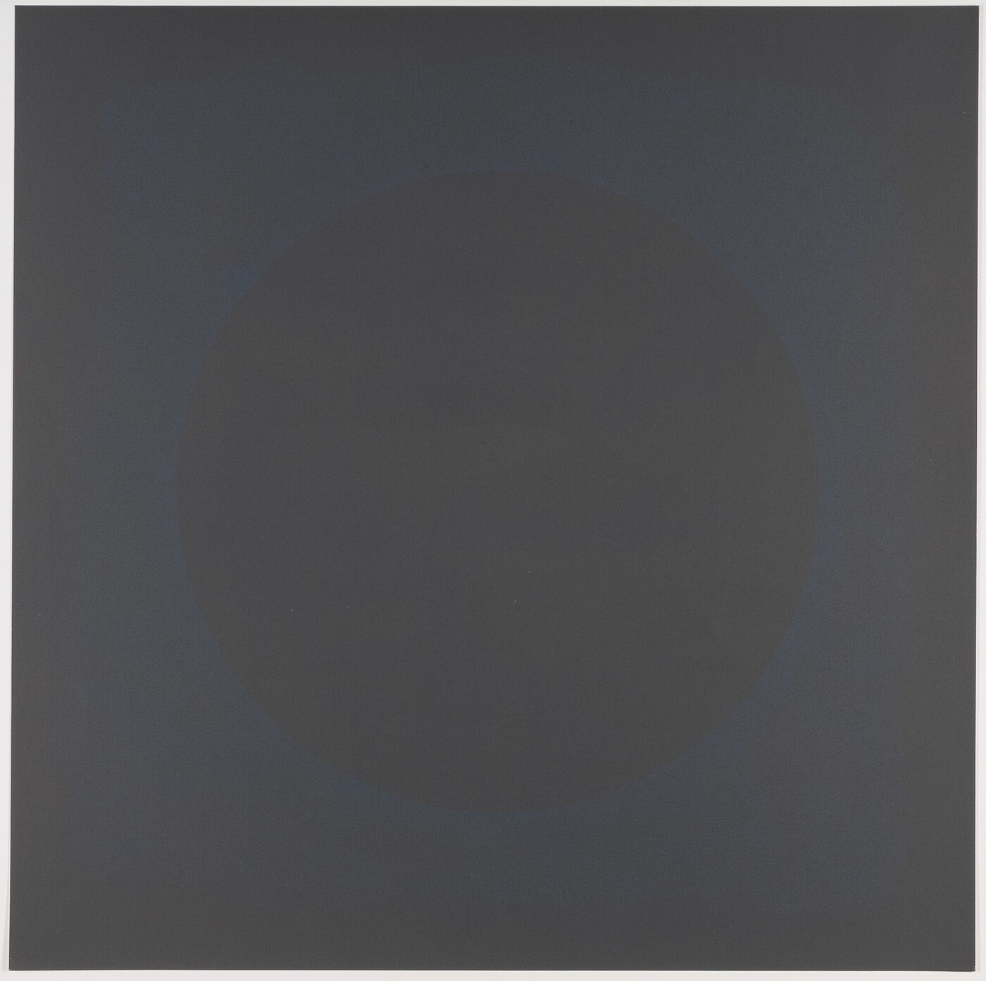 A color print of a circle defined by faint a blue spattered outline in the center of a dark gray square.