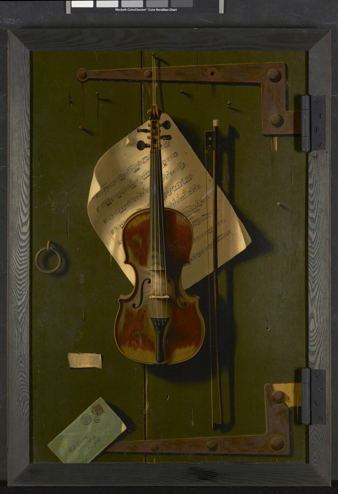 A realistic color print of a violin and bow hanging on a green, wood door with sheet music tacked behind the violin.