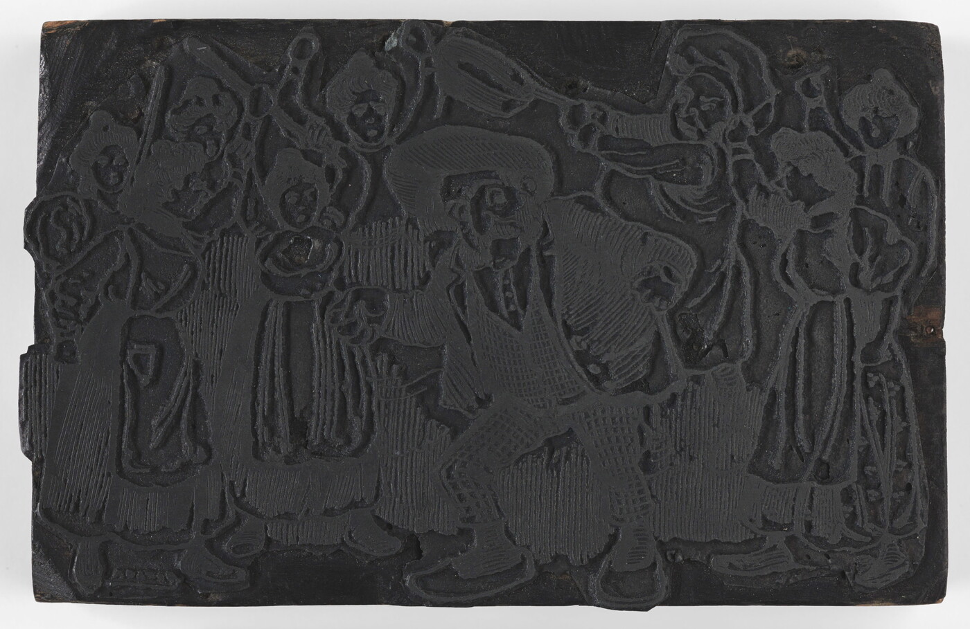 An engraved metal printing plate of a group of figures with cooking implements attacking a bearded man in the center.