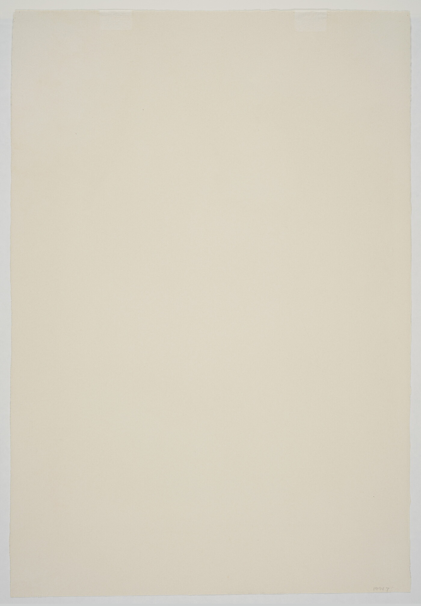 A black-and-white print of a large boulder with a vertical crack in the middle and a leafless tree on the top.