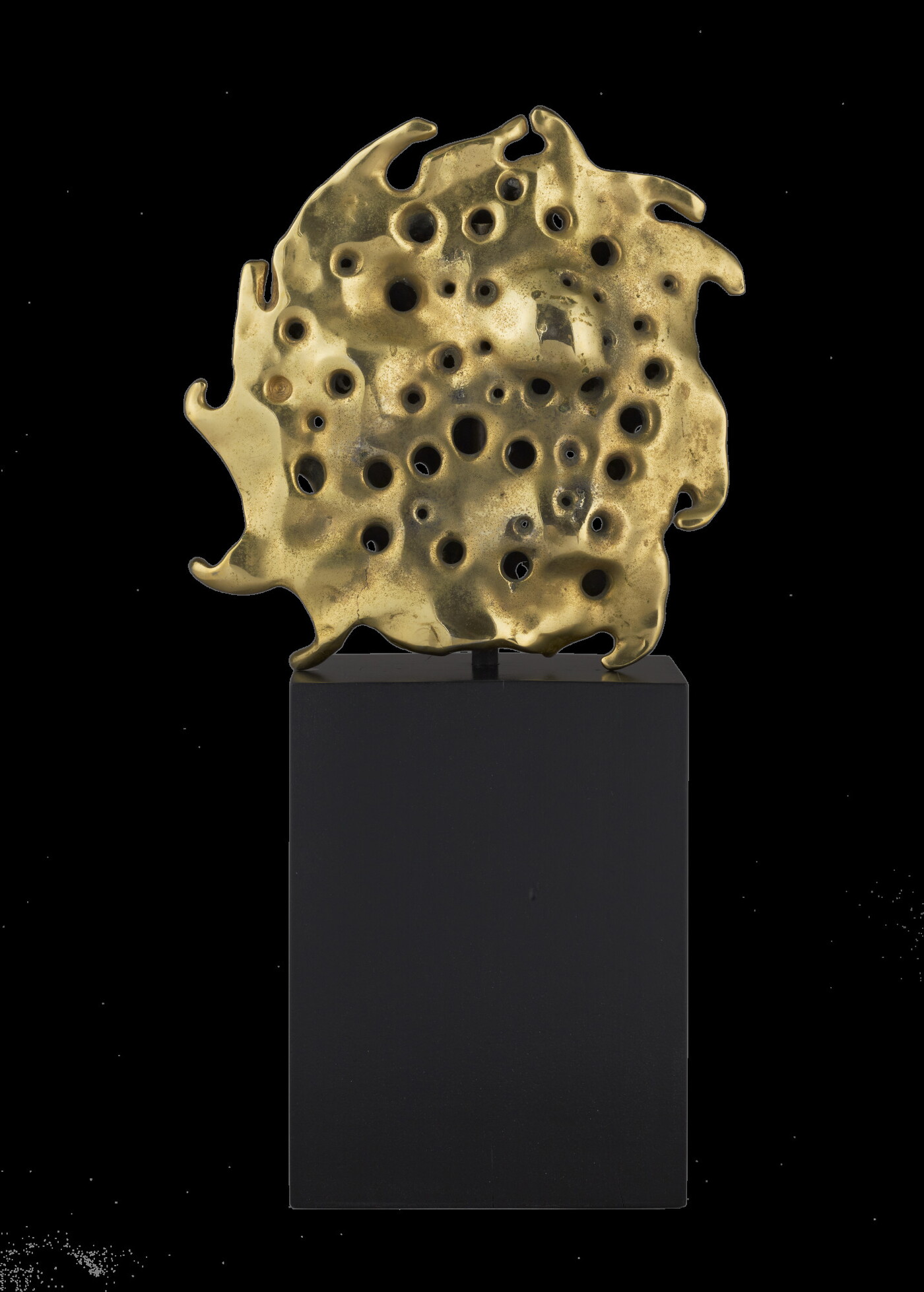 A bronze sculpture of a gold sun sitting atop a tall, dark rectangular base.