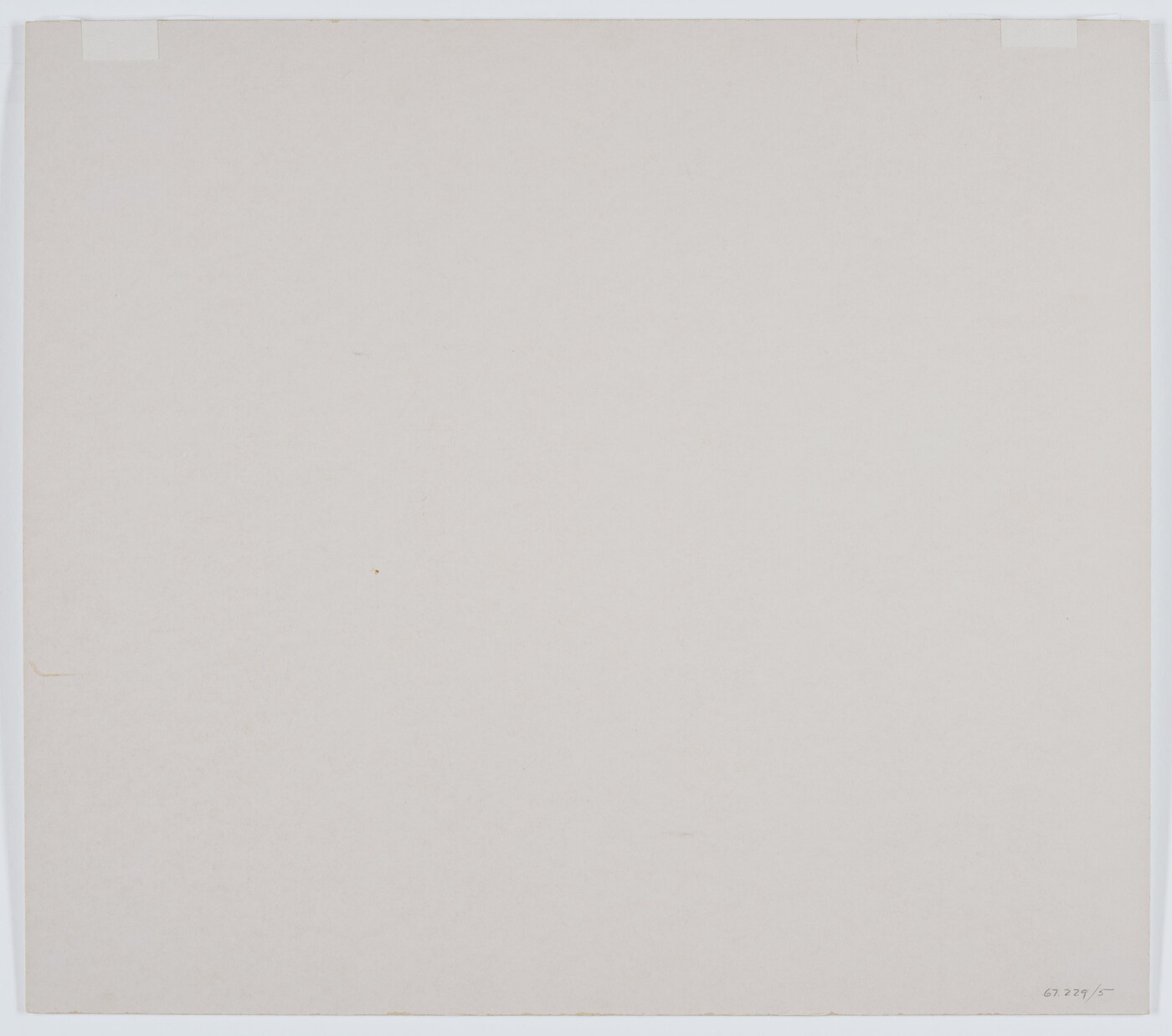 A black-and-white photograph of a rowboat on a sandy beach and three more out on still water with hills in the distance.