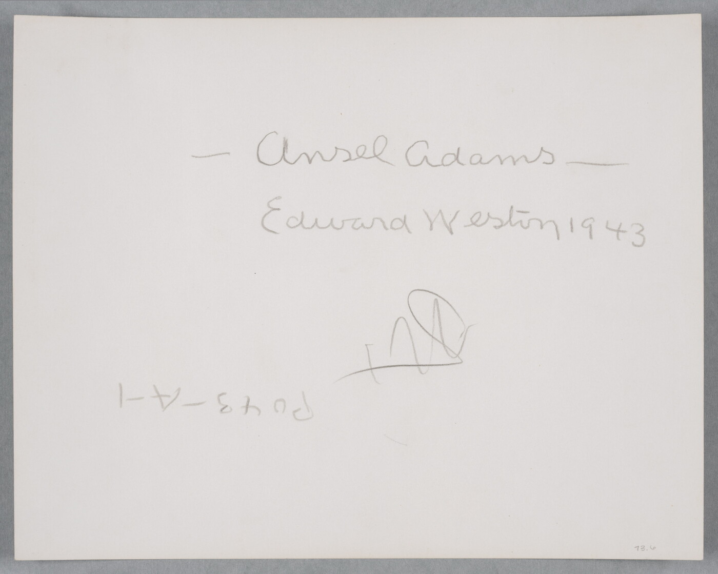 A black-and-white photograph of a bald, White man standing next to a wood structure, wearing a suit jacket and resting his head in his hand.