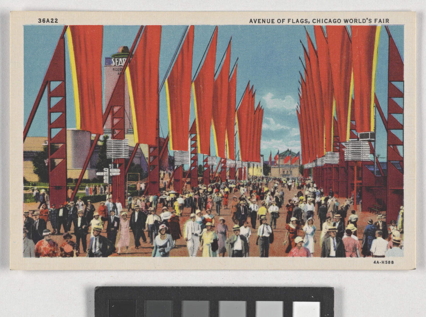 A color postcard of crowds of people walking down a large pathway flanked by bright red flags on a clear, blue day.