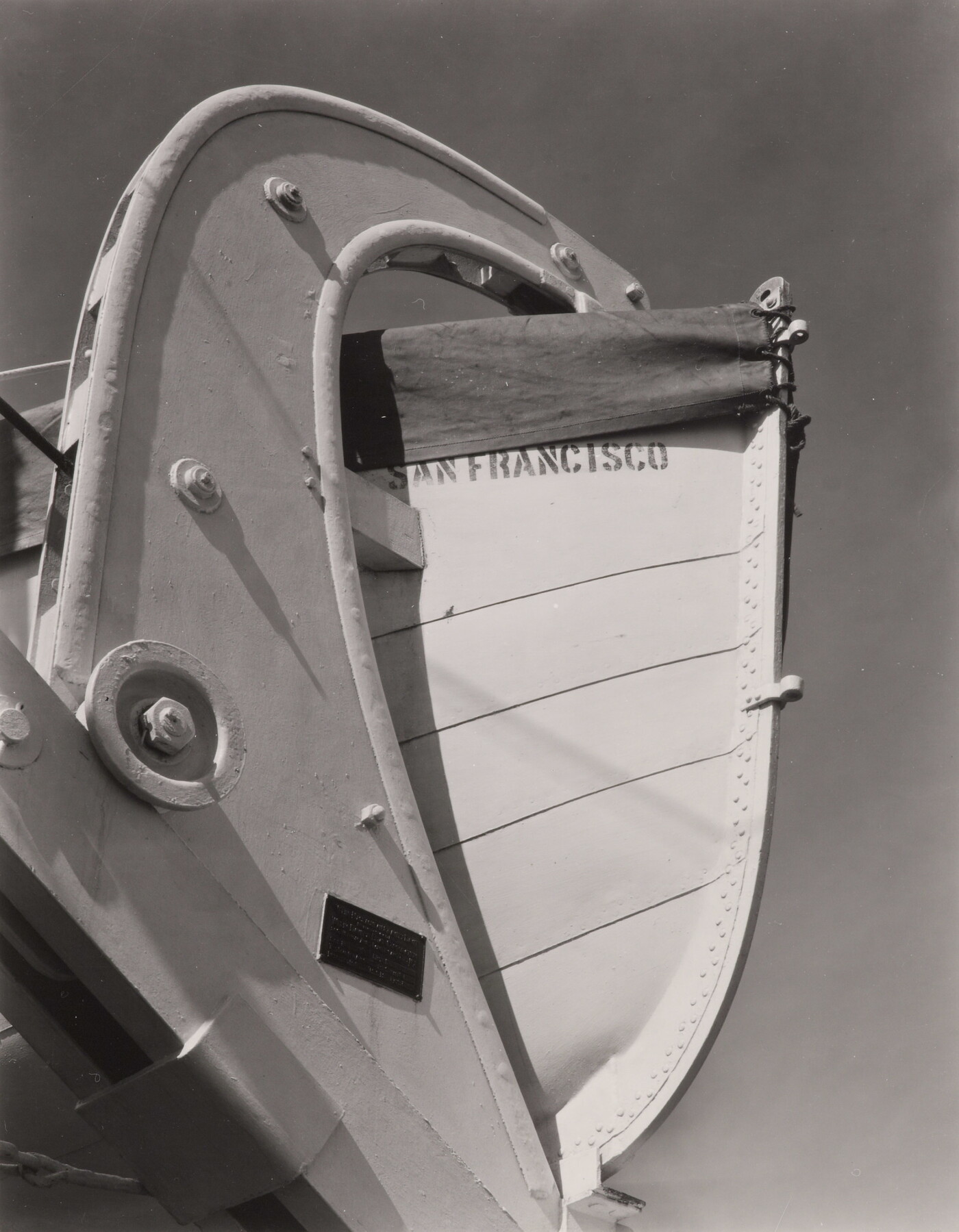 A black-and-white photograph of a lifeboat stern and its mount with the words &quot;San Francisco&quot; painted on the hull.