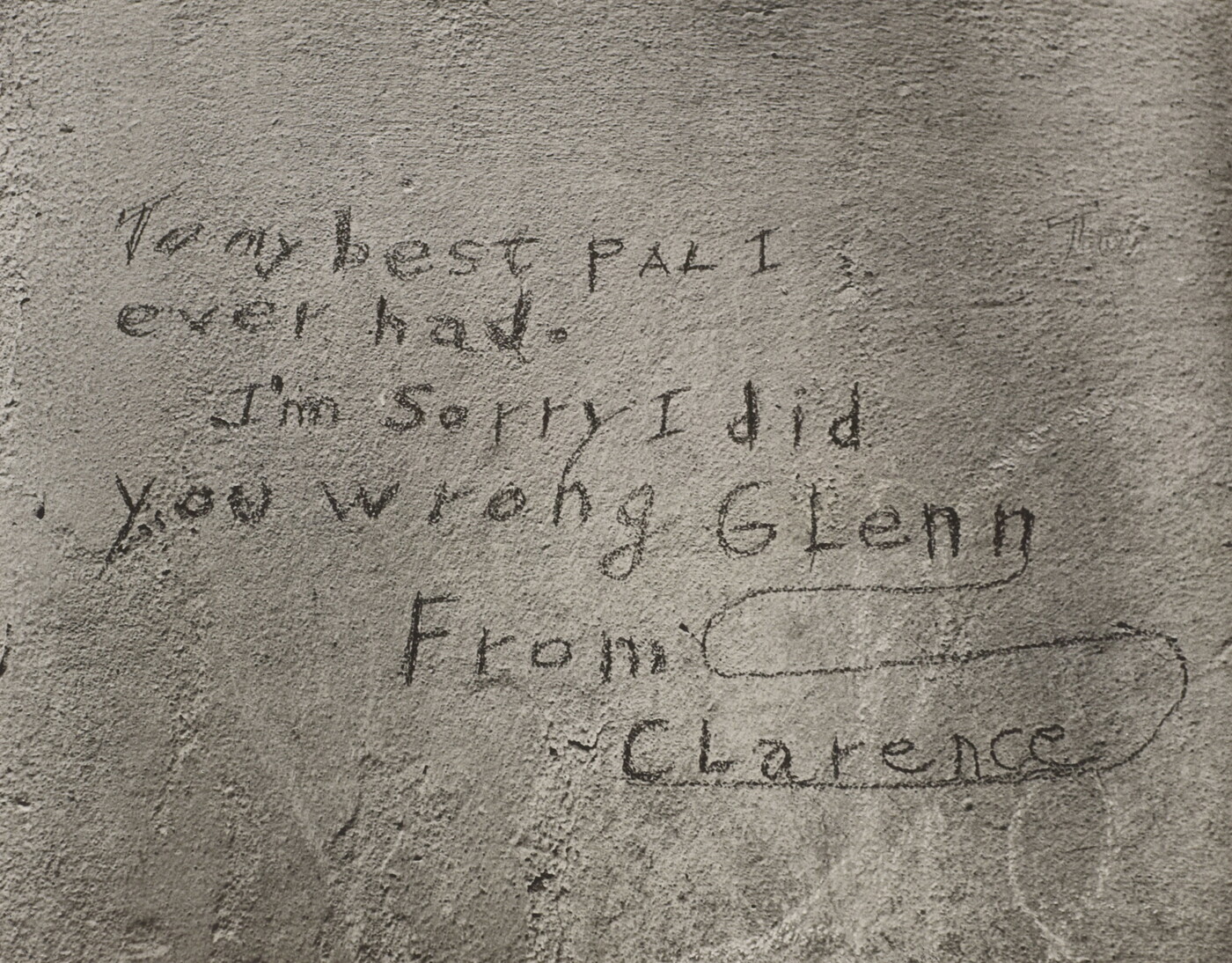 A black-and-white photograph of a note written on what looks like a cement wall that reads: &quot;To my best pal I ever had. I&#039;m sorry I did you wrong Glenn. From Clarence.&quot;