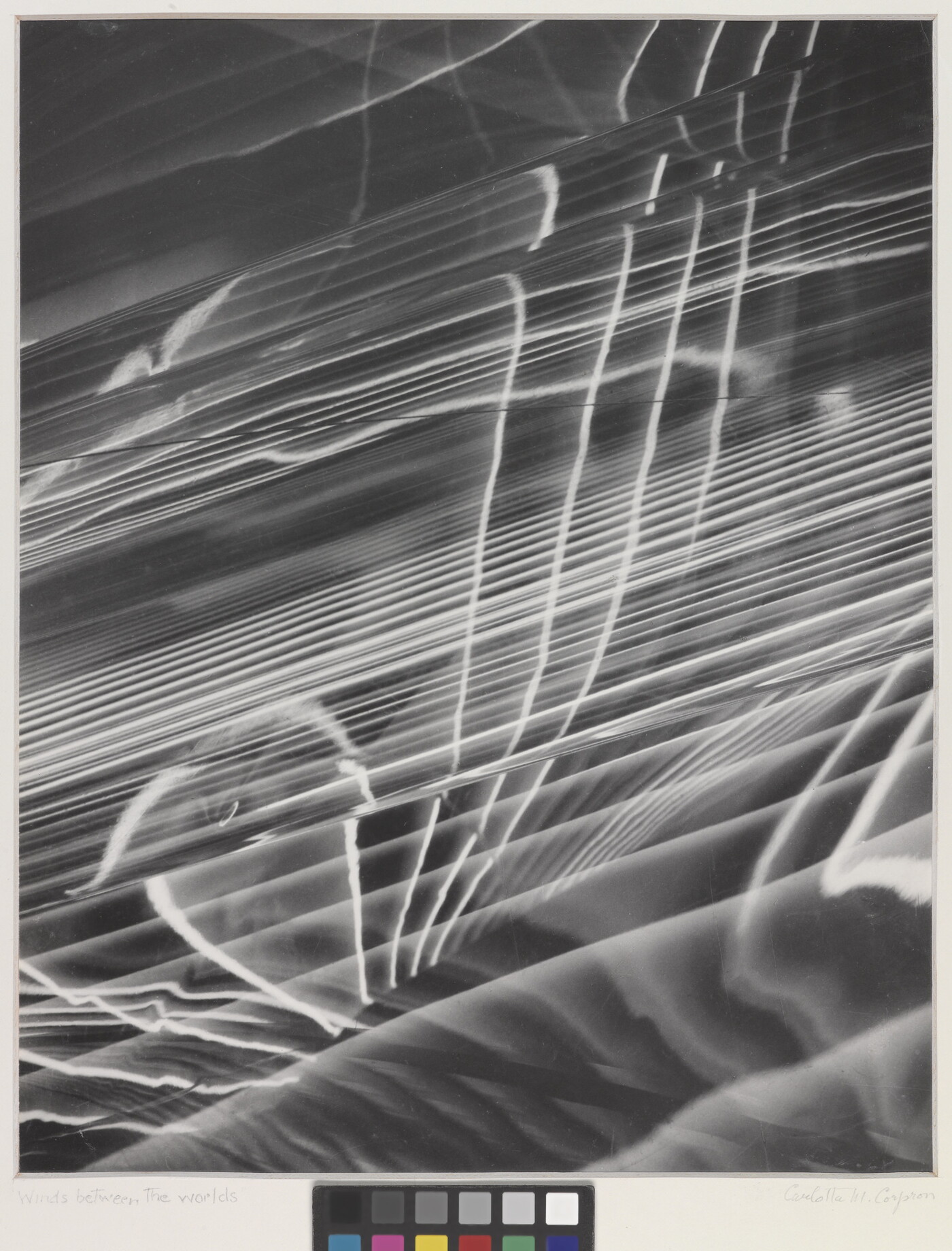 A black-and-white photograph of abstract white lines radiating horizontally, layered on top of a rippled background.