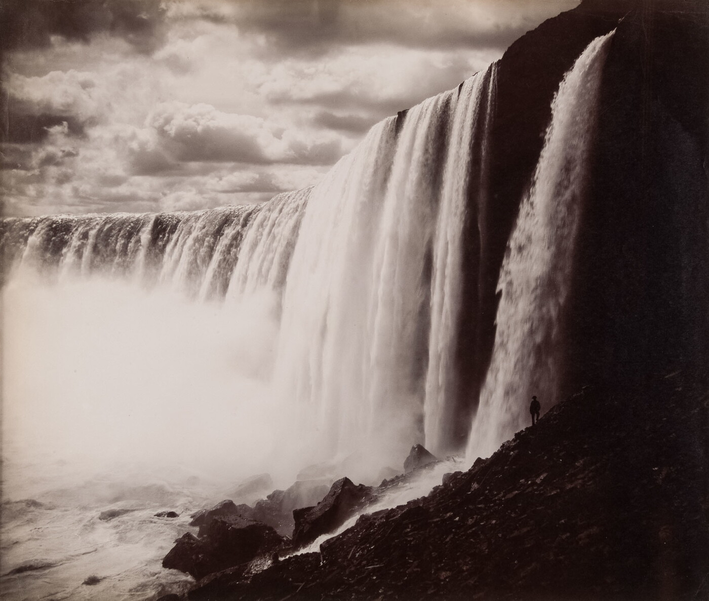 A black-and-white photograph of a large waterfall.