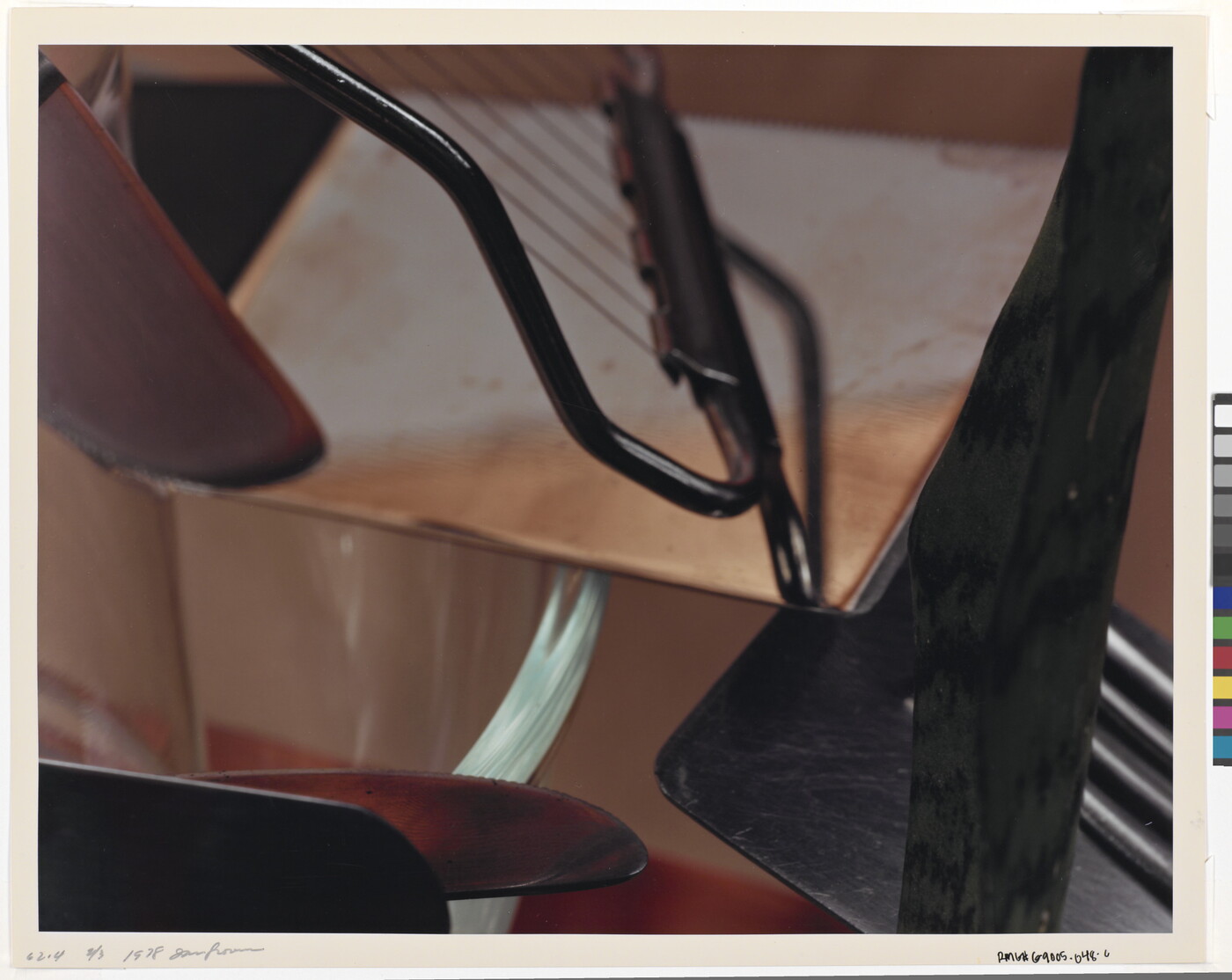 A close-up, color photograph of everyday kitchen implements arranged in an abstract composition.
