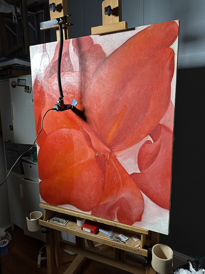 An oil painting on an easel with a small camera scanning its surface.