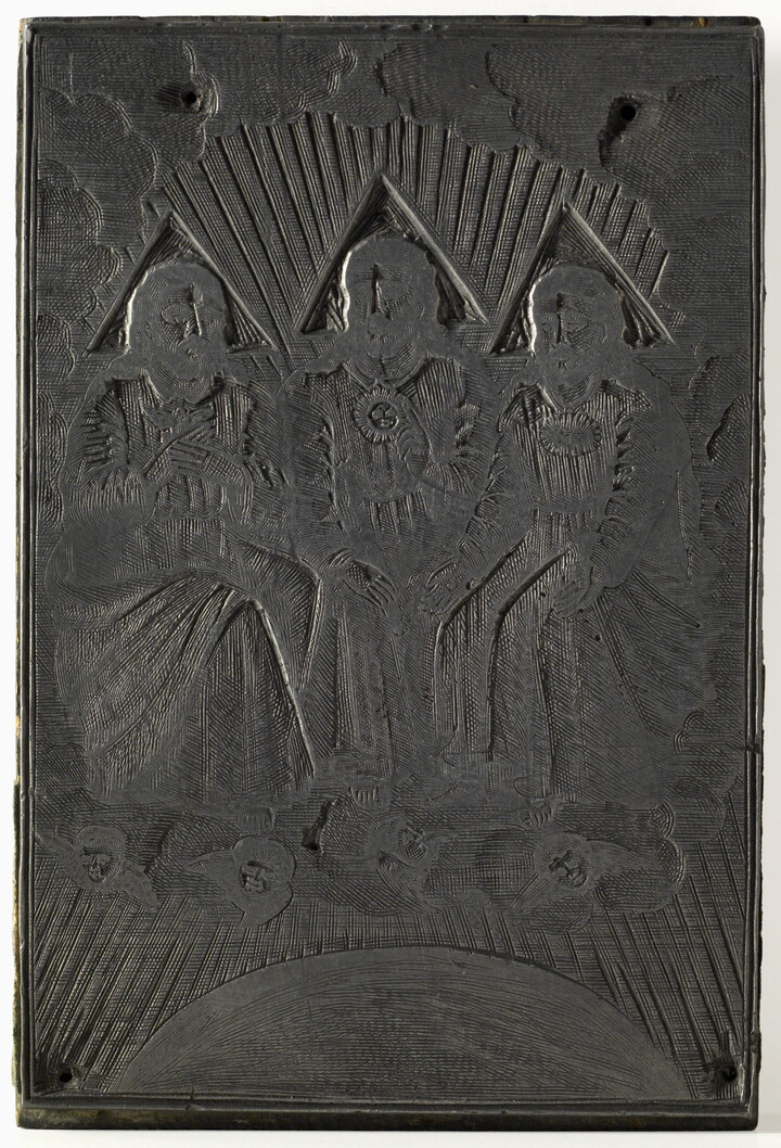 An engraved metal printing plate of three seated male figures draped in robes seated on thrones on a cloud.