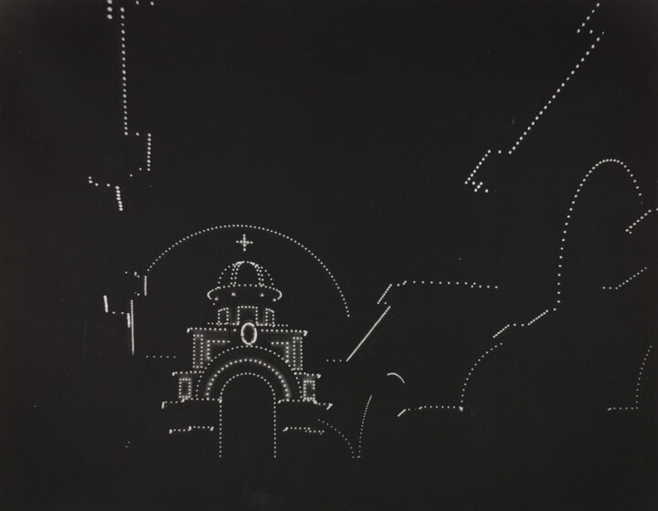 A black-and-white photograph with a pure black background and dotted white lights outlining the shape of a domed cathedral.