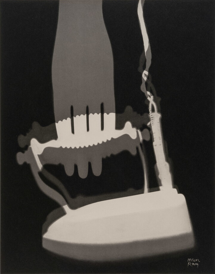 An abstract black-and-white photograph of white and gray silhouettes of what looks like an iron and a fork.