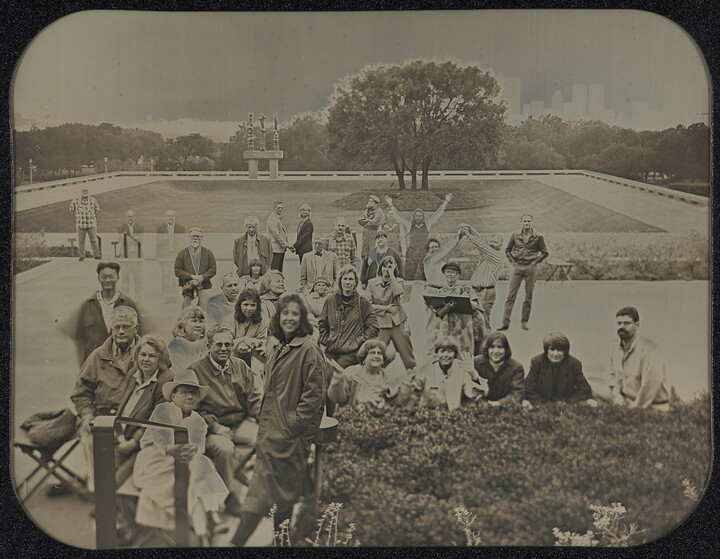 A black-and-white photograph of a group of people posing on the plaza in front of the Carter.