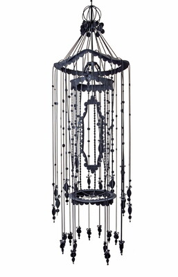 A hanging object that resembles a birdcage with stings of beaded fringe around the outside.