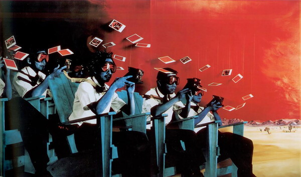A color photograph of people all wearing safety goggles and dressed in white shirts and black pants, sitting in rows of blue Adirondack chairs, holding Polaroid cameras as photos of a nuclear cloud fall around them.
