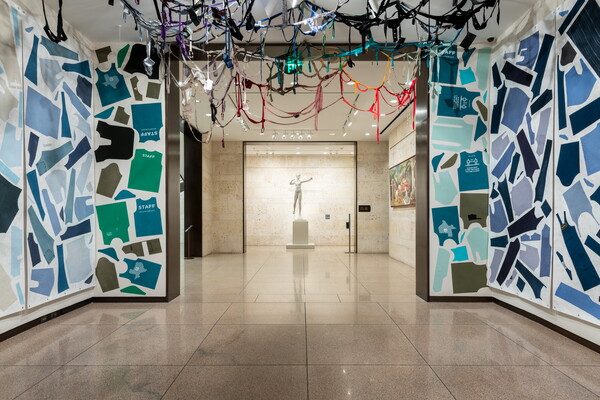 A Carter gallery with the walls and ceiling covered with cut up pieces of clothing.