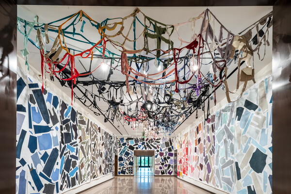 A Carter gallery with the walls and ceiling covered with cut up pieces of clothing.