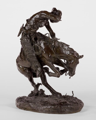 A sculpture of a man riding a bucking horse around a rattlesnake.