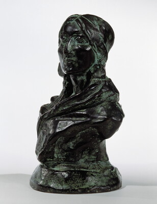 A bronze sculpture with a slight green patina of the bust of an American Indian woman.