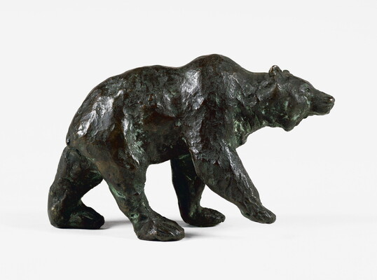 A bronze sculpture of a walking bear.