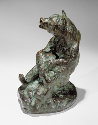 A bronze sculpture of a sitting bear holding a jug in its paws.
