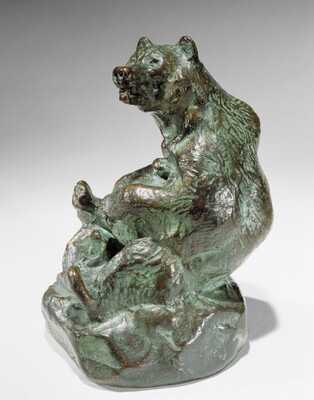 A bronze sculpture of a sitting bear holding a jug in its paws.