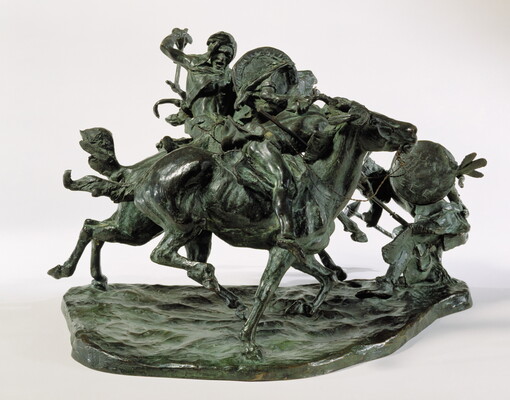 A bronze sculpture of two horses in mid-gallop, with both riders lunging toward a crouching man behind a shield.