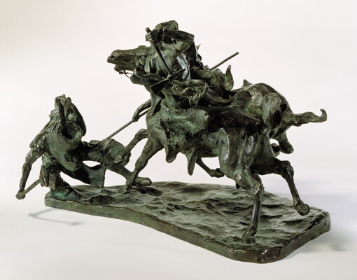 A bronze sculpture of two horses in mid-gallop, with both riders lunging toward a crouching man behind a shield.
