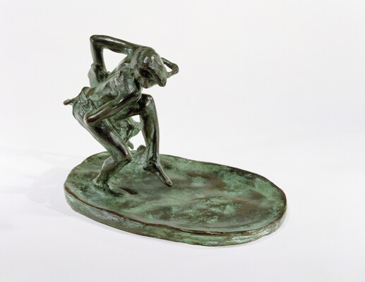 A bronze sculpture of an Indigenous man dancing with a wolfskin in his hand.